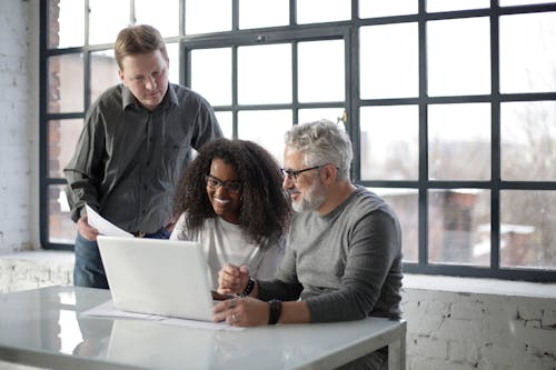 Multiethnic coworkers on laptop in office