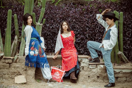 Group of young adults wearing traditional Mexican attire posed outdoors in León, Mexico.