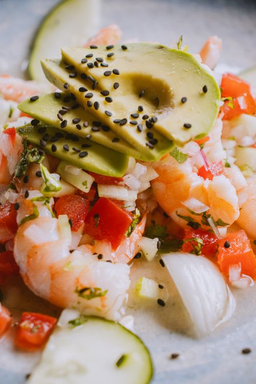 Free A vibrant dish of shrimp ceviche garnished with avocado and fresh vegetables, perfect for a summer meal. Stock Photo