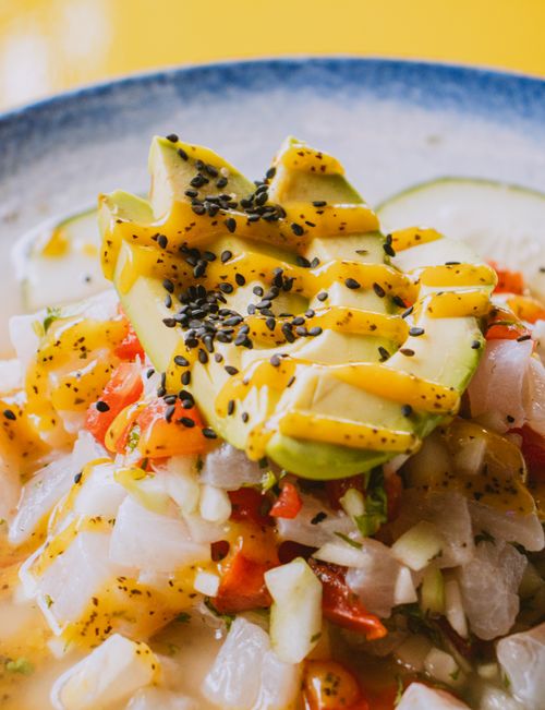 Free Colorful ceviche with fresh avocado slices, vibrant vegetables, and black sesame seeds. Stock Photo