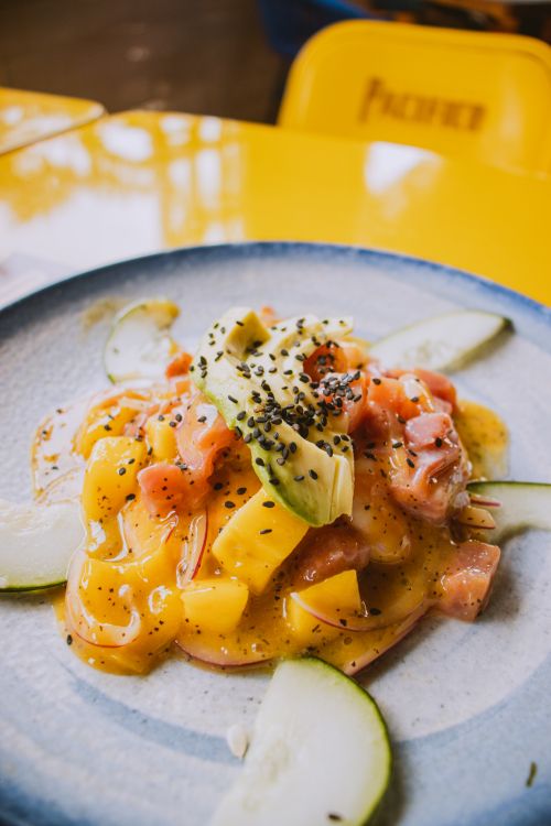 Free A fresh and vibrant mango and salmon salad garnished with avocado and sesame seeds. Stock Photo