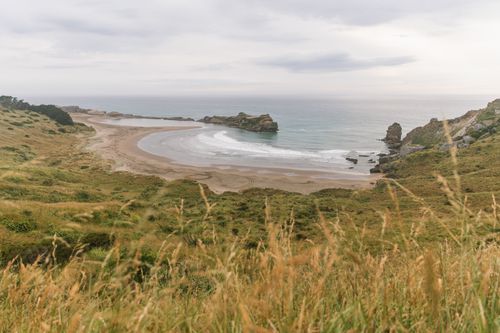 Free Breathtaking view of Castlepoint Beach in New Zealand, capturing its stunning cliffs and ocean waves. Stock Photo
