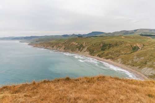 Free Stunning view of Castlepoint coastline in New Zealand with rugged cliffs and the Pacific Ocean's expanse. Stock Photo