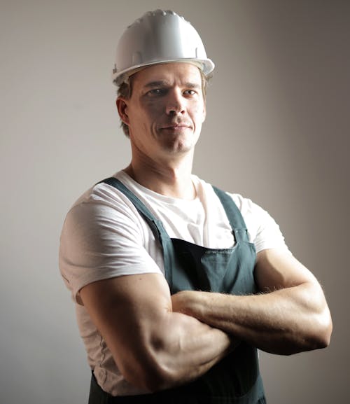 Free Serious adult constructor in helmet and uniform Stock Photo