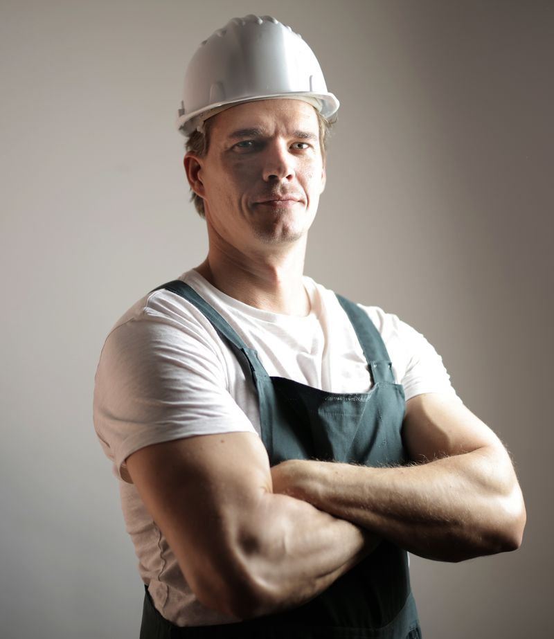 Confident KM Door Company constructor in uniform with hardhat