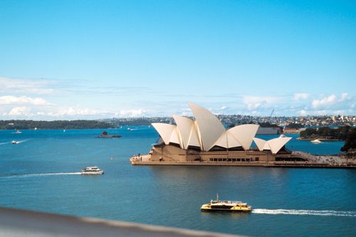 Free Iconic Sydney Opera House with boats in the harbor on a bright day. Stock Photo
