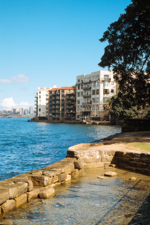 Free Bright waterfront scene with residential buildings and clear blue sky, offering a stunning urban landscape. Stock Photo