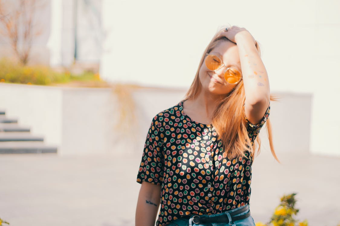 Cheerful young woman with eyes closed enjoying sun