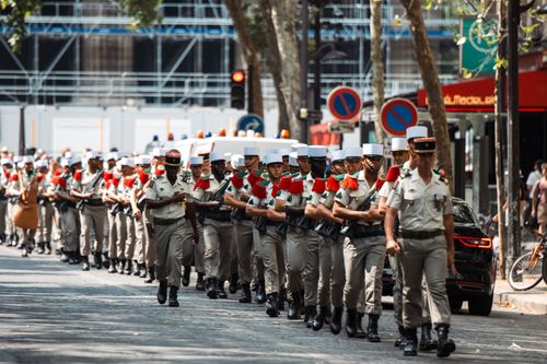Free French Foreign Legion soldiers march in a parade on Paris streets, showcasing military precision and discipline. Stock Photo