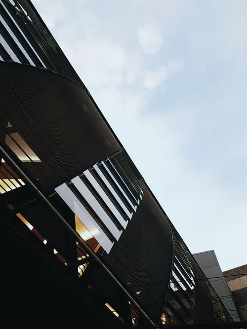 Free Low angle of contemporary office building with concrete and glass mirrored walls located in business district Stock Photo