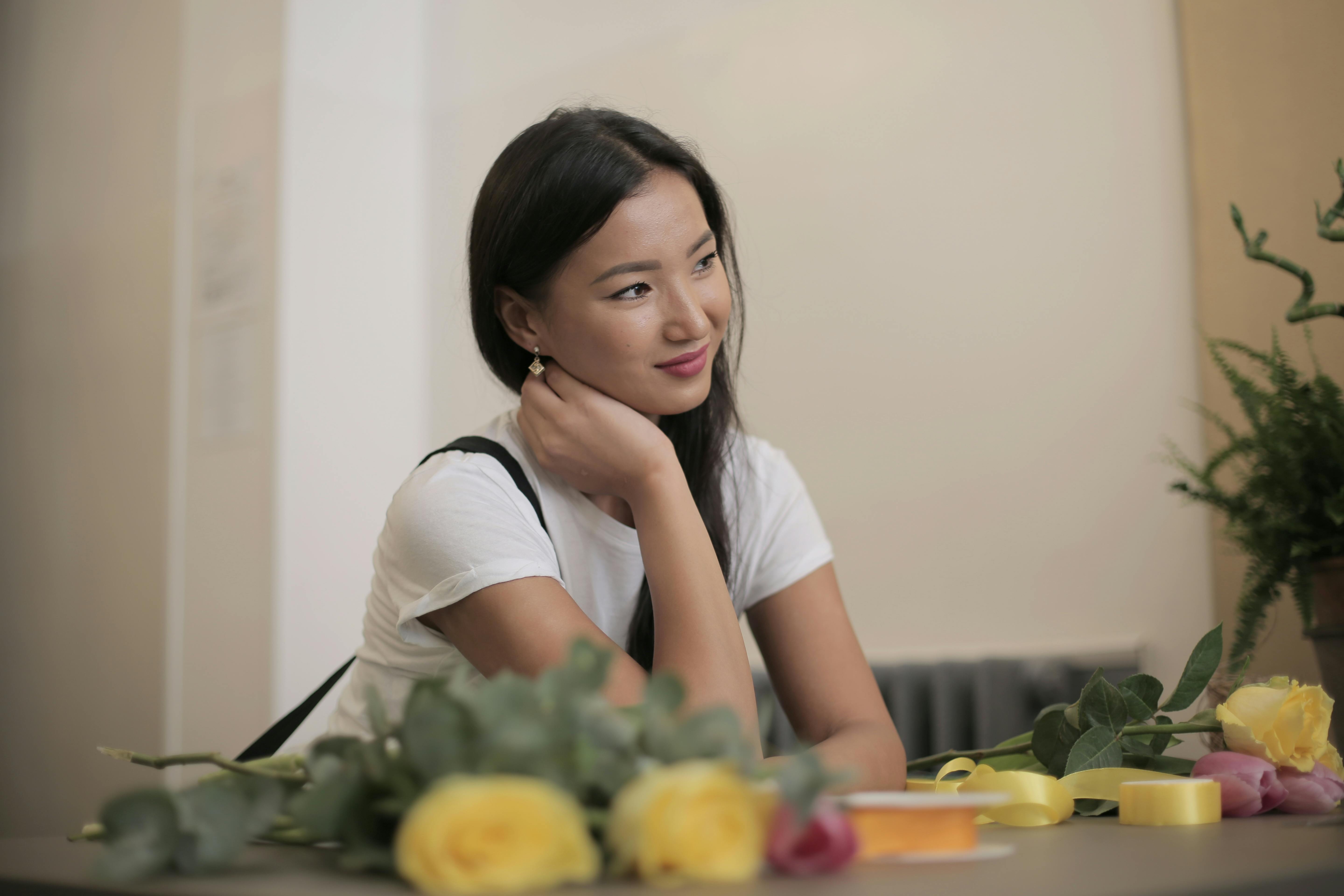 positive ethnic businesswoman at own floral shop