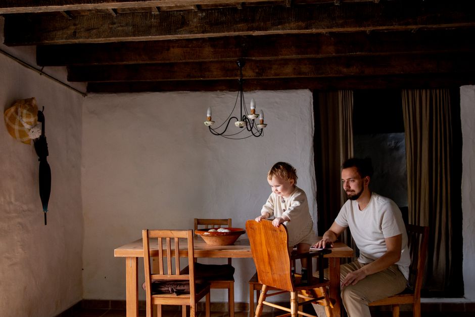 Padre y niña pasando tiempo de calidad en un interior rústico, enfatizando la unión familiar y la comodidad.