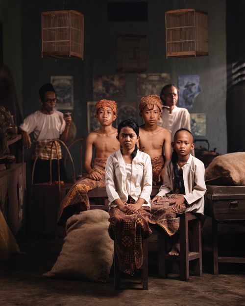 Free Traditional Javanese family portrait indoors with cultural attire reflecting Indonesian heritage. Stock Photo