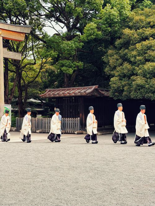 Free Shinto priests in traditional attire walking in procession at Meiji Shrine, Tokyo. Stock Photo