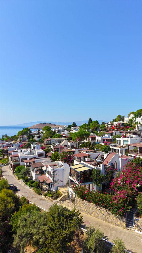 Free Aerial view of Bodrum's charming coastal homes and seascape under clear blue skies. Stock Photo