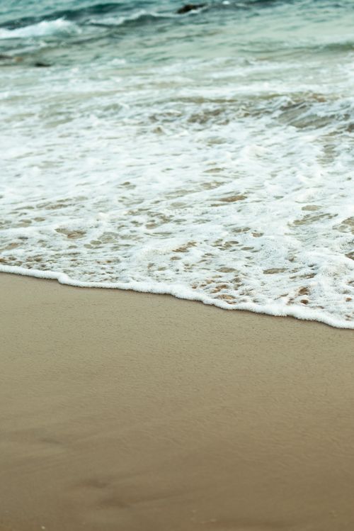 Free Gentle ocean waves wash onto a sandy beach in Morocco. Stock Photo