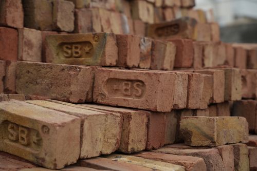 Free Close-up of red bricks with the 'SB' logo, showcasing construction materials. Stock Photo