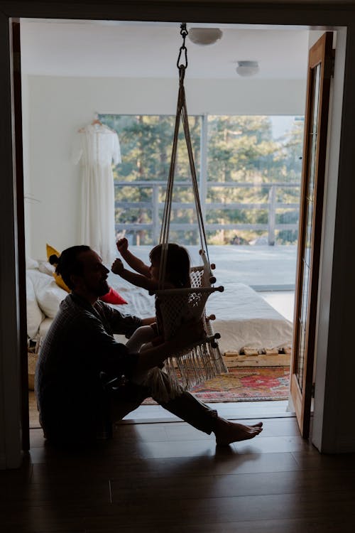 Free Father playing with daughter on floor in cozy room Stock Photo