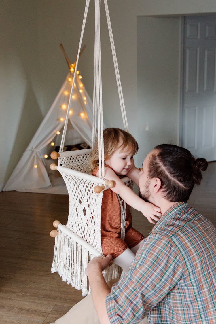 Cheerful Girl On Swing With Dad