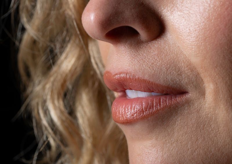 Lips and nose in warm tone after lip correction