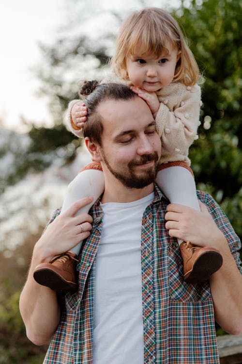 A Man Carrying his Daughter on his Shoulders