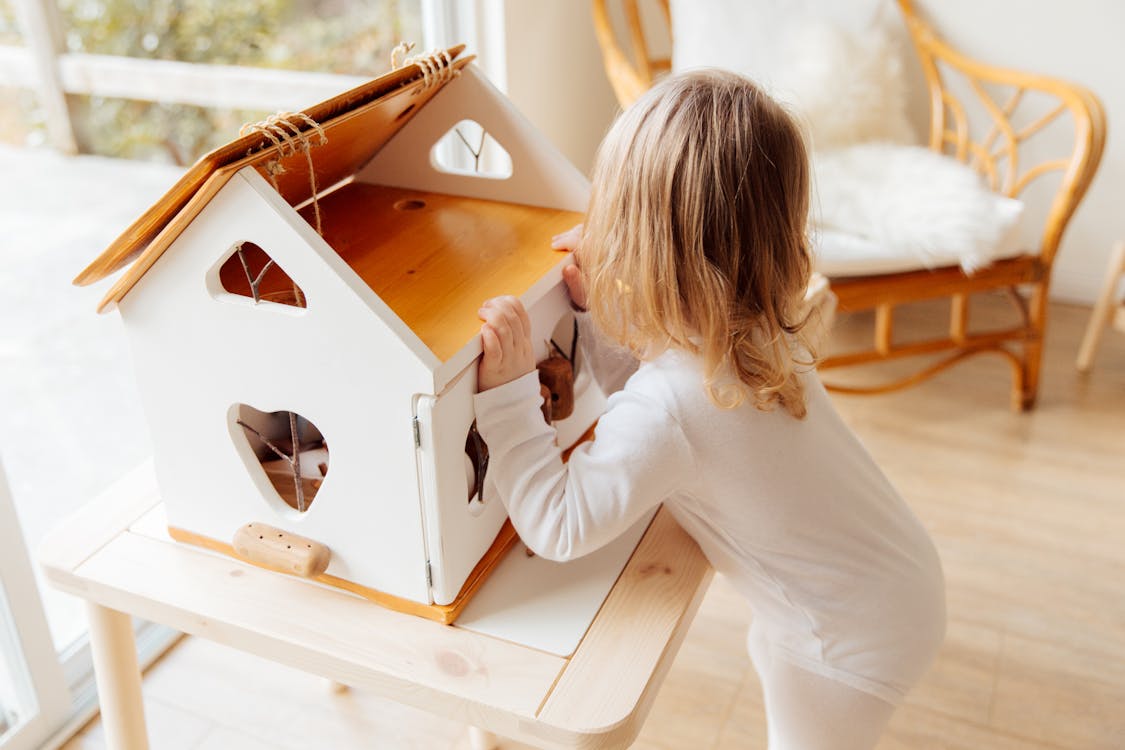 Girl Playing With A Wooden Box 