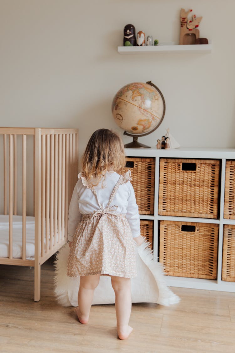 Little Girl Spending Time In Cozy Living Room At Home