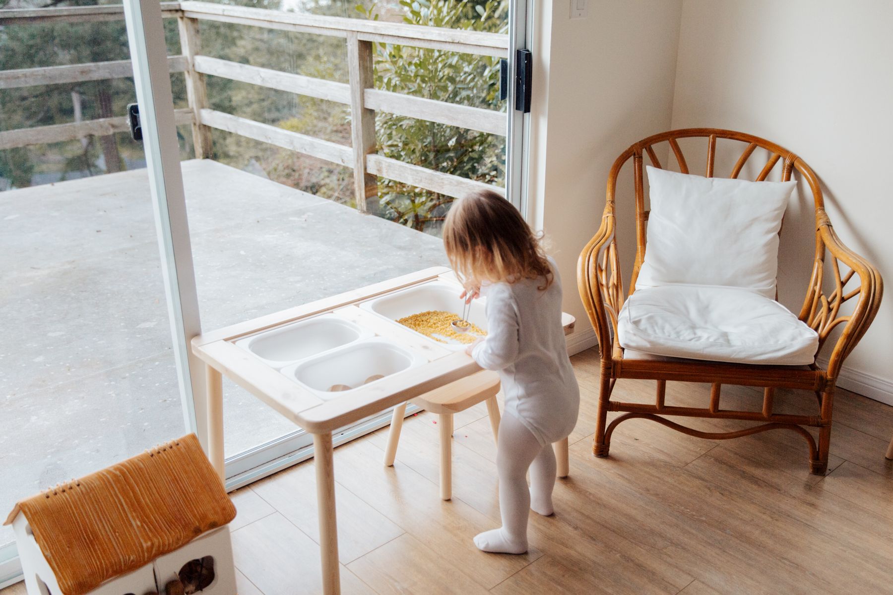 Child enjoying hands-on toy play at a table in a bright home environment