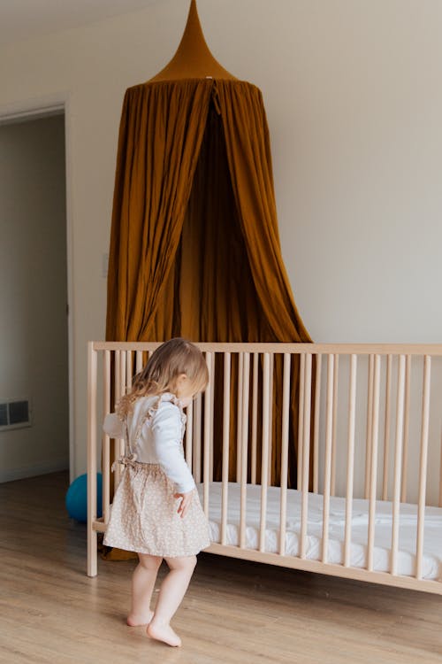 Free Photo Of Child Standing Near Crib Stock Photo