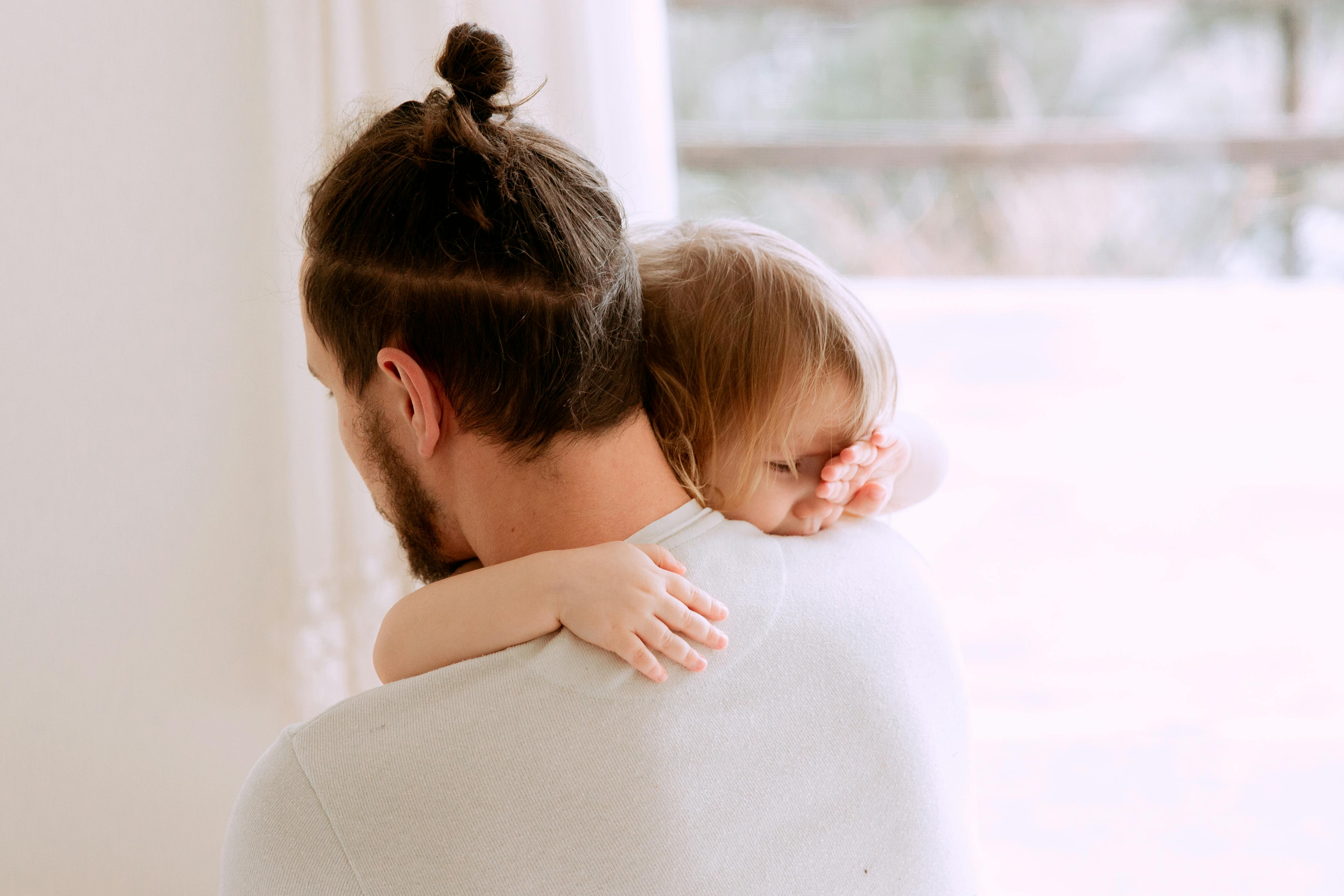 photo of man carrying child