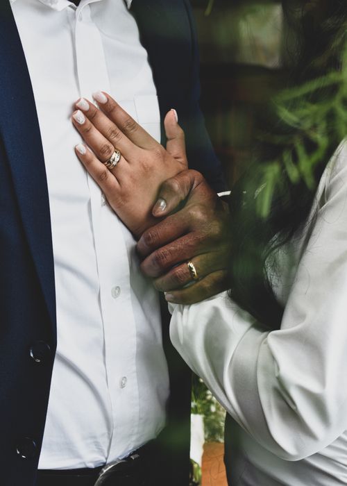 Free Close-up of a couple showing their wedding rings during a ceremony, symbolizing love and commitment. Stock Photo