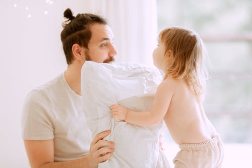 Photo Of Man Holding Pillow