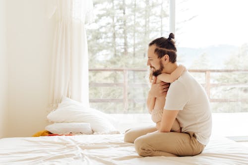 Free Photo Of Man Hugging Child Stock Photo