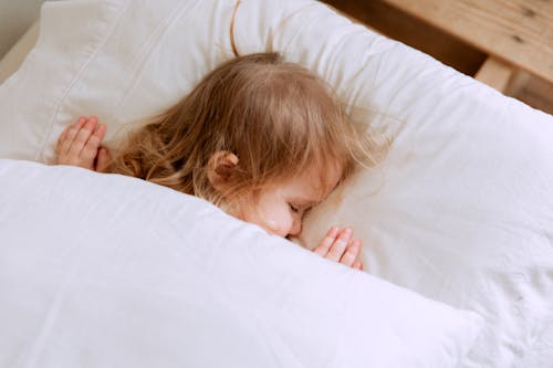 Free Photo Of Child Laying On Bed Stock Photo