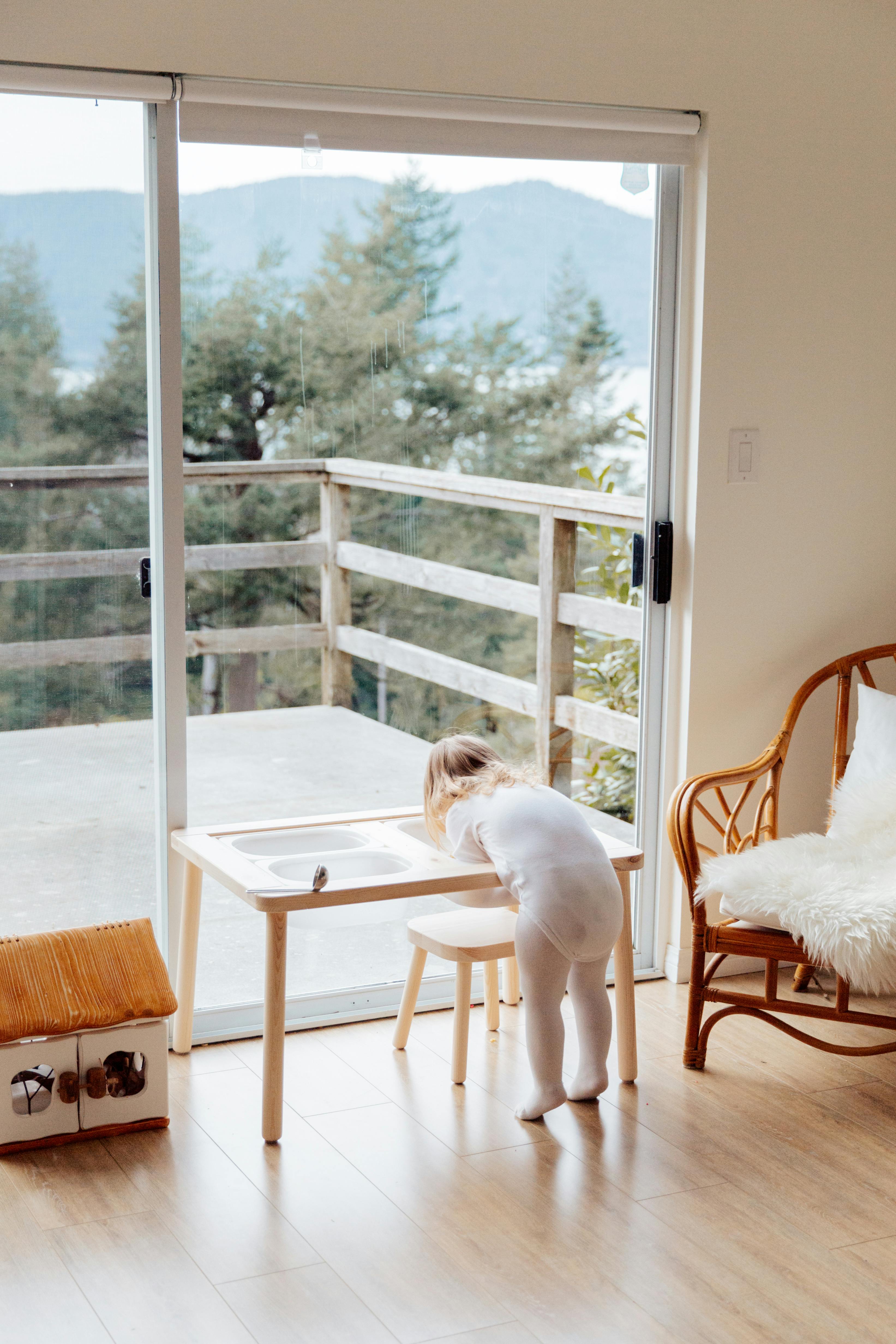 photo of child near wooden chair