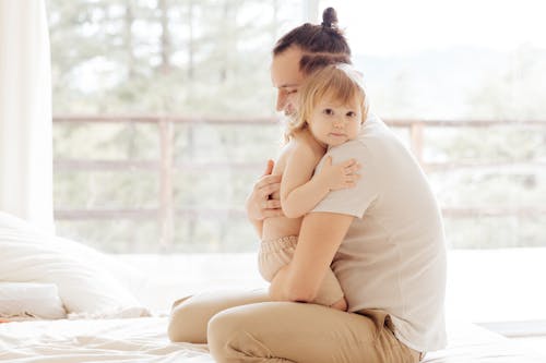 Free Photo Of Man Hugging Child Stock Photo