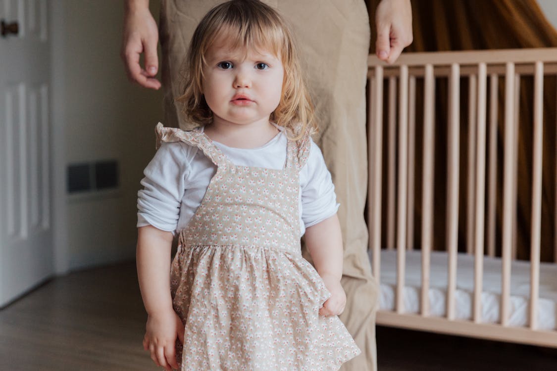 Free Little Girl in White Shirt and Floral Dress  Stock Photo