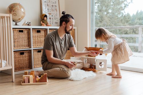Free A father and daughter enjoy playtime indoors, sharing a precious parenting moment. Stock Photo