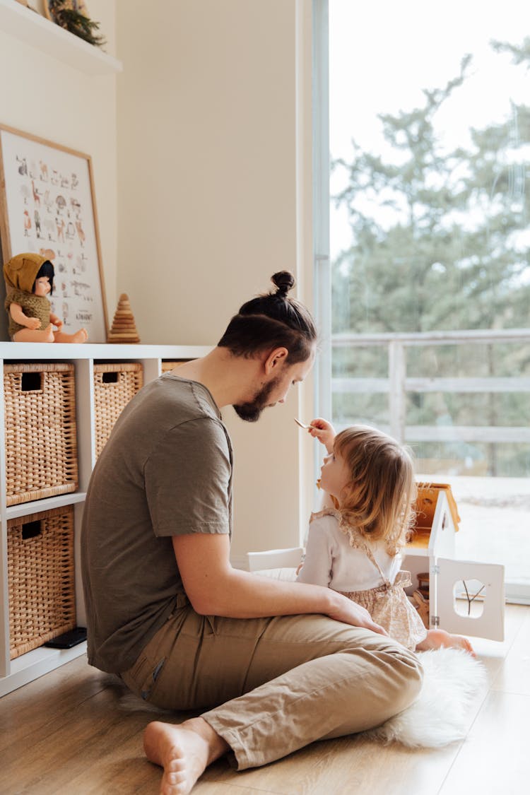 Photo Of Man Playing With Child