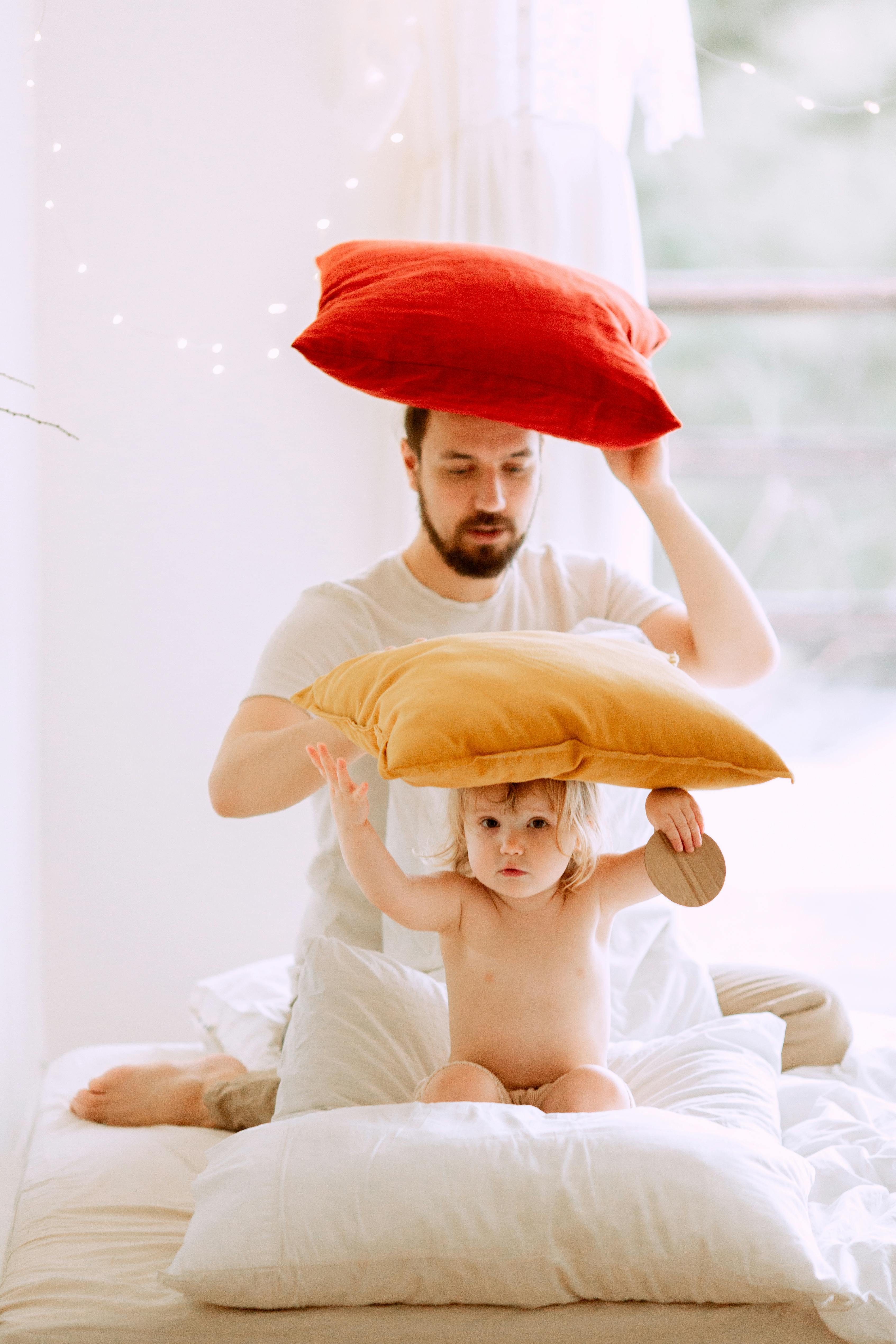 photo of man holding red pillow