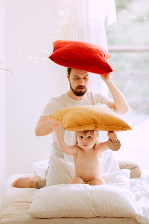 Photo Of Man Holding Red Pillow