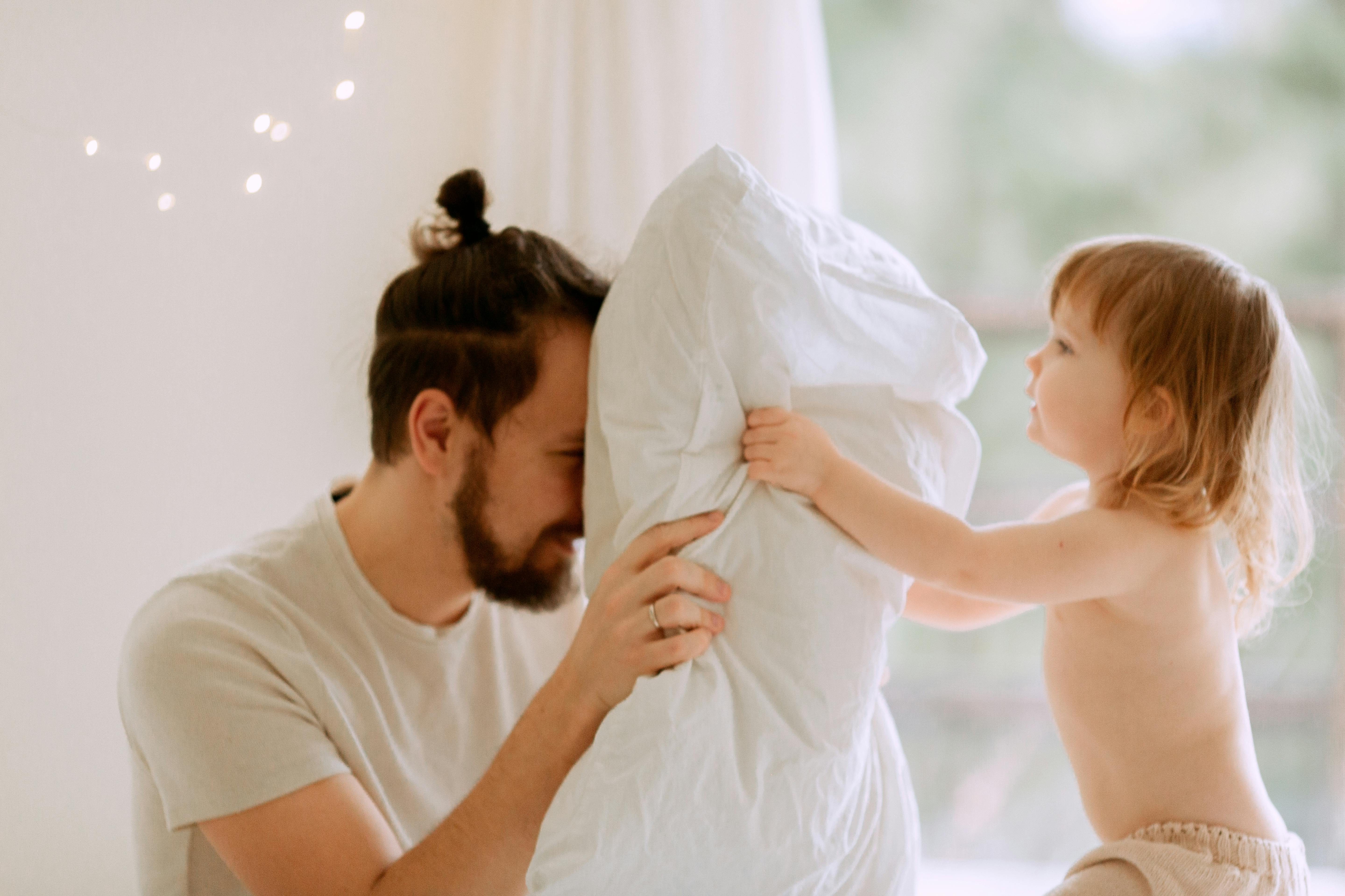 photo of man holding pillow