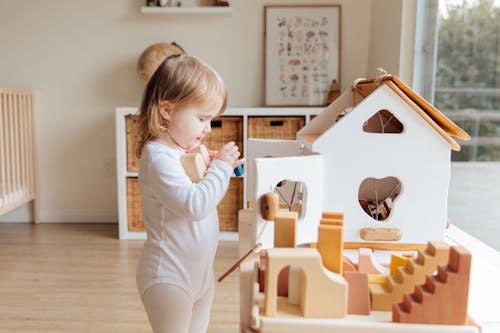 Free Photo Of Child Holding Wooden Blocks Stock Photo