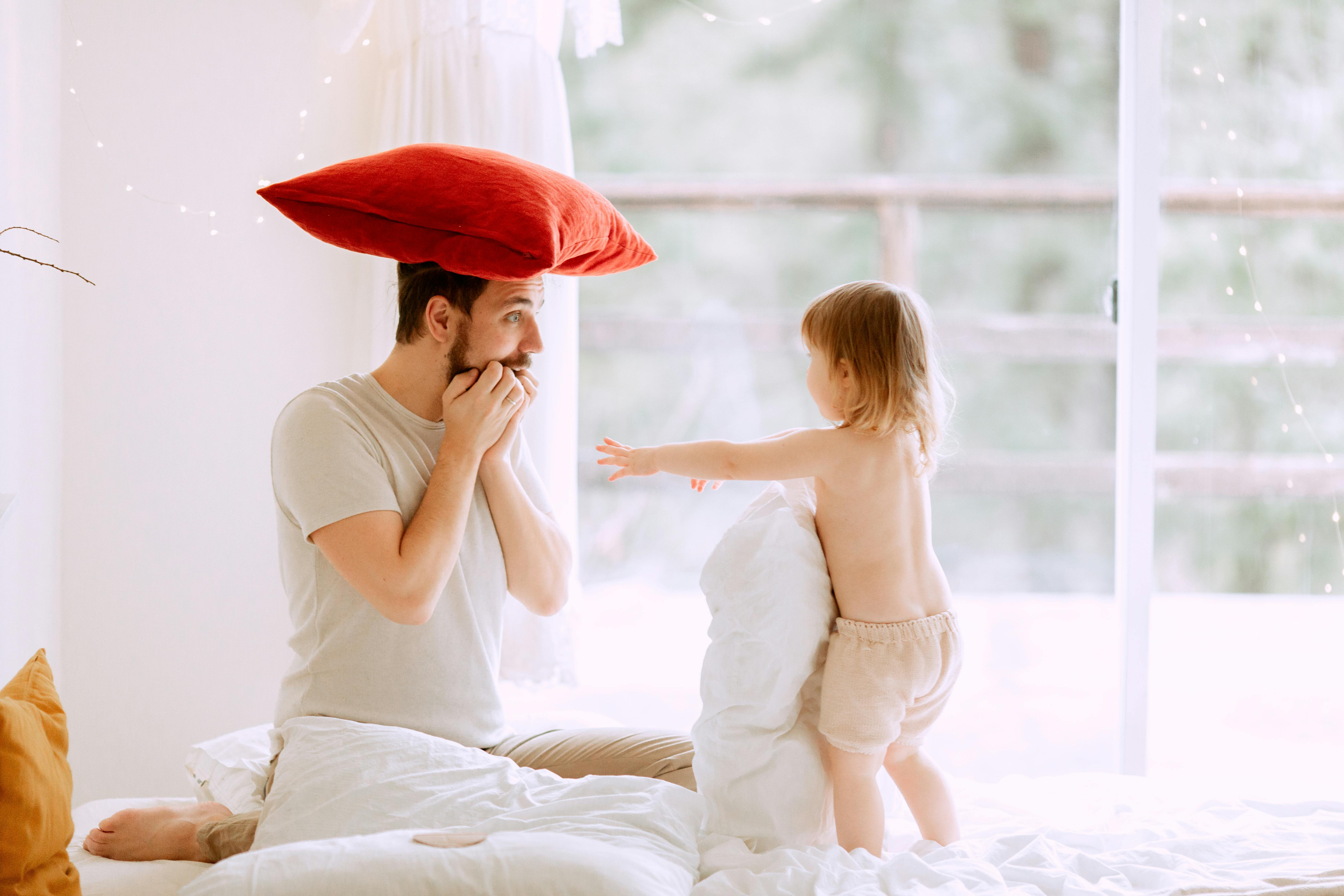 photo of man with red pillow on his head