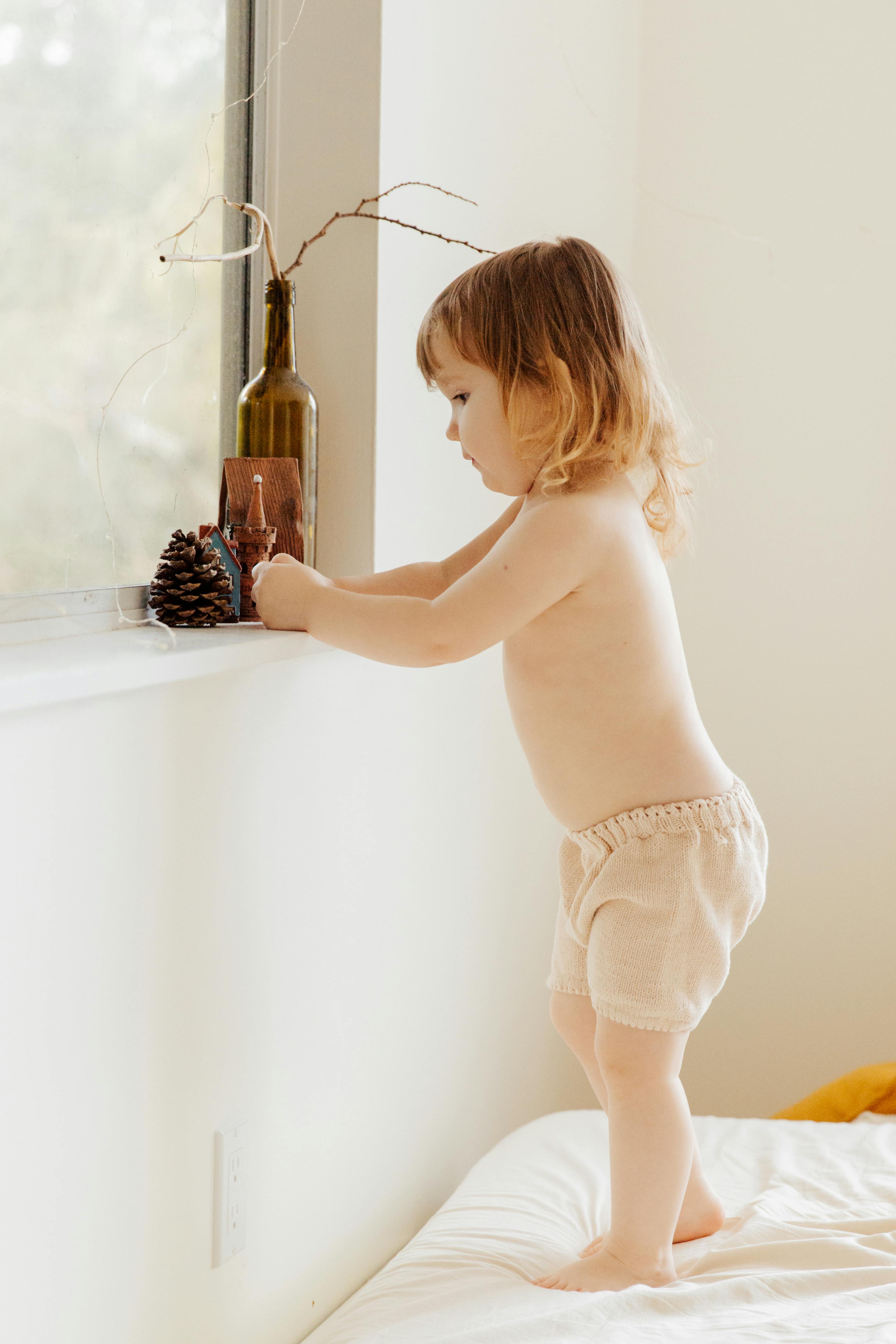 photo of child near window