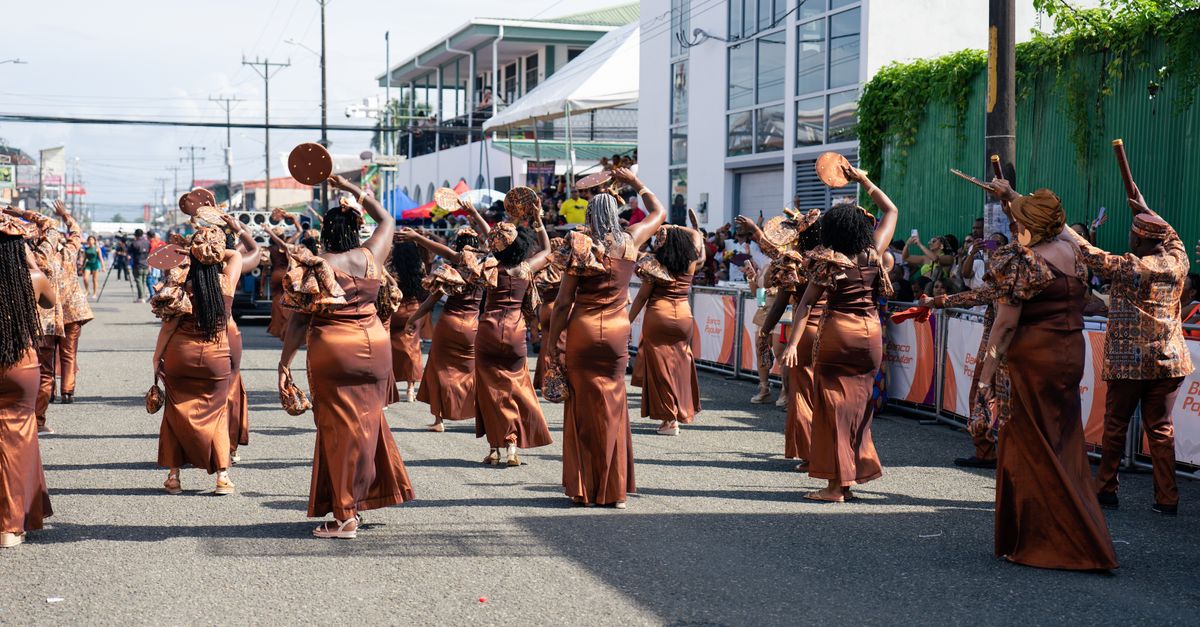Vibrant parade with dancers in traditional costumes in Limón, Costa Rica.
