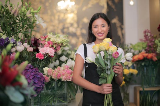 Happy florist with a bouquet of flowers in a vibrant flower shop.