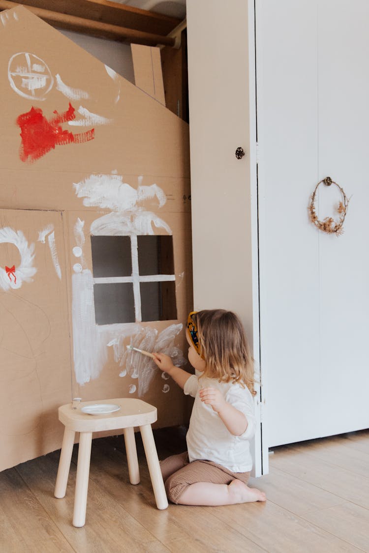 Girl Painting Cardboard House