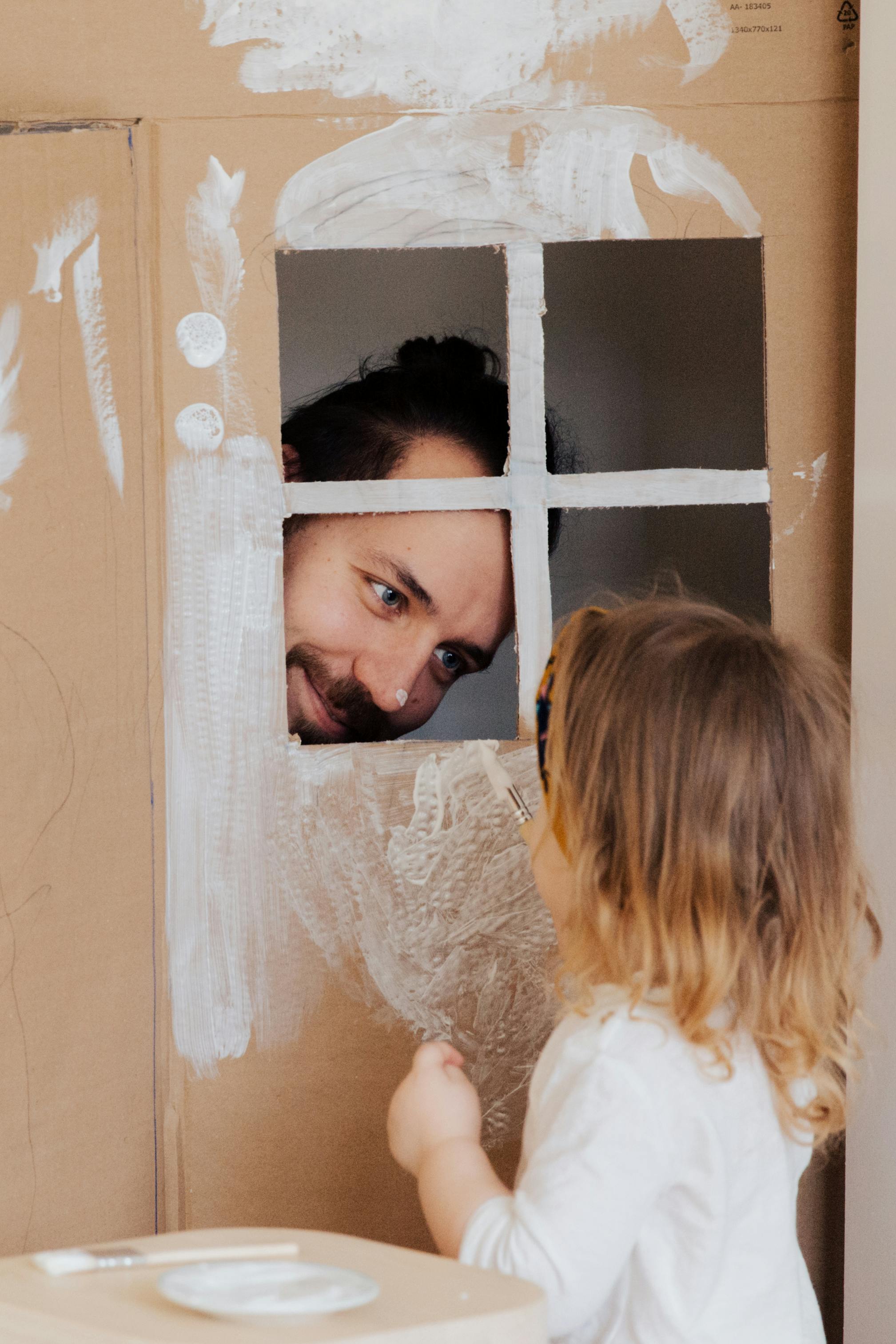 a man playing with his little daughter