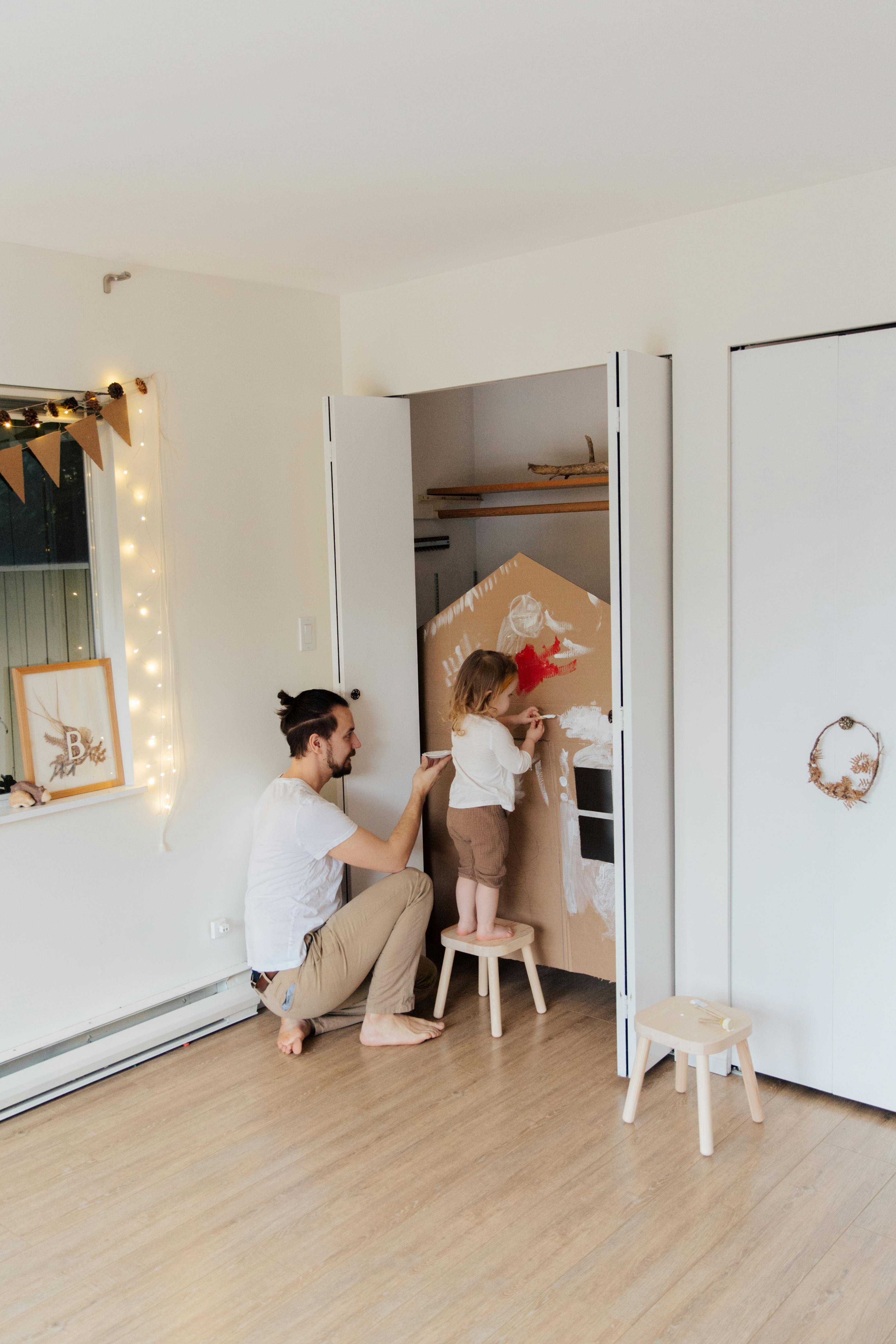 photo of baby standing on stool